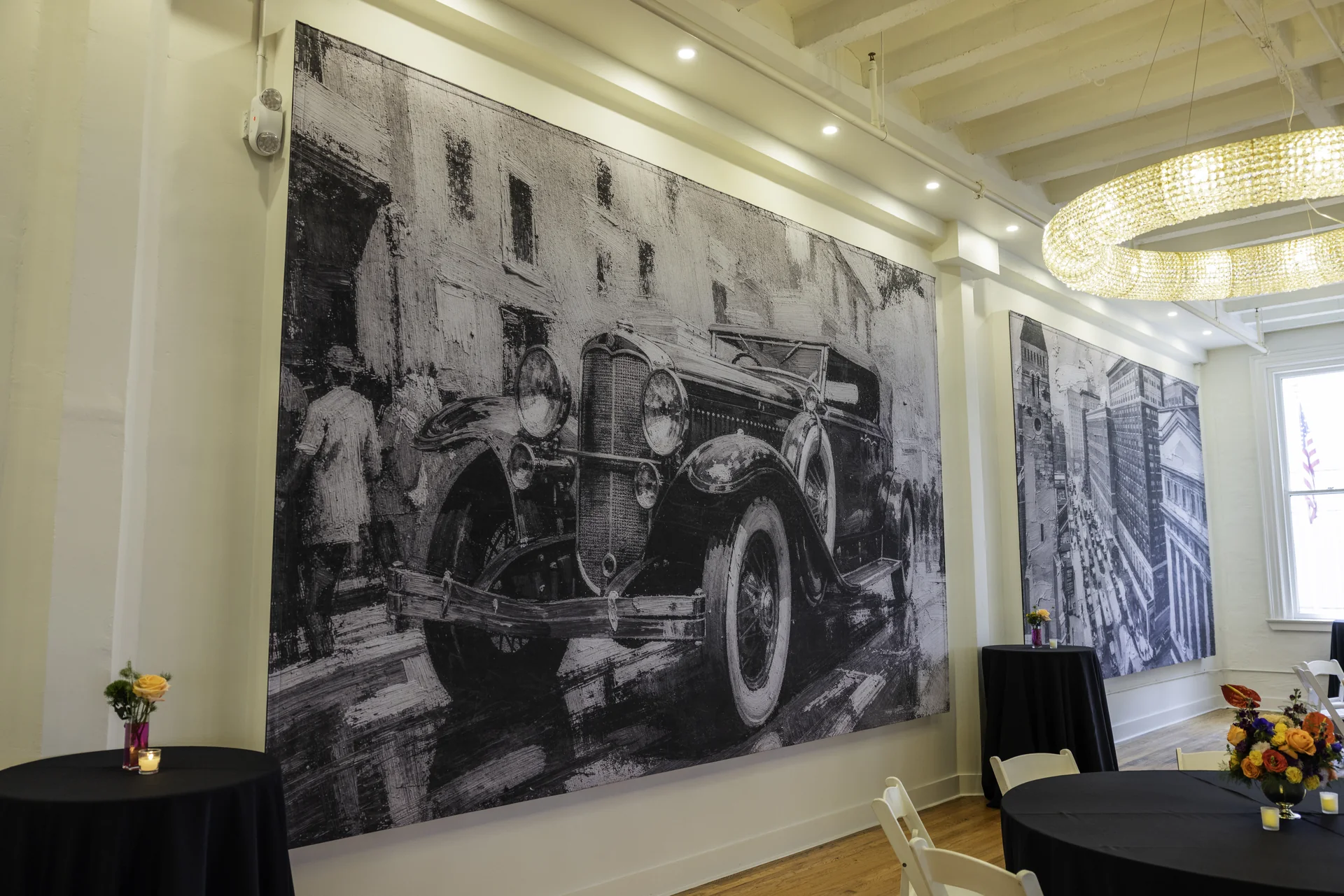 A vintage automobile artwork beneath a crystal chandelier inside Grand Ballroom.